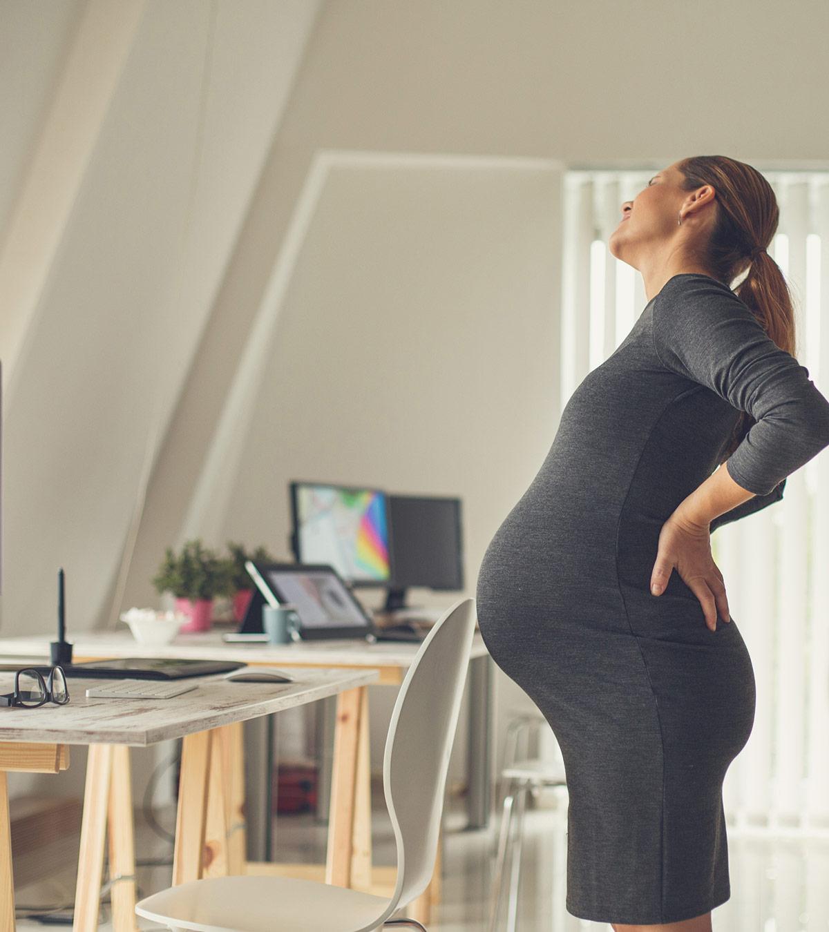 Pregnant woman holding her side to relieve gallbladder pain
