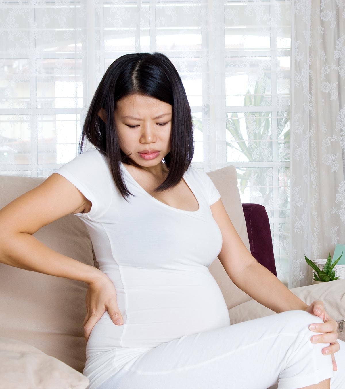 Pregnant woman using a pillow for pelvic support