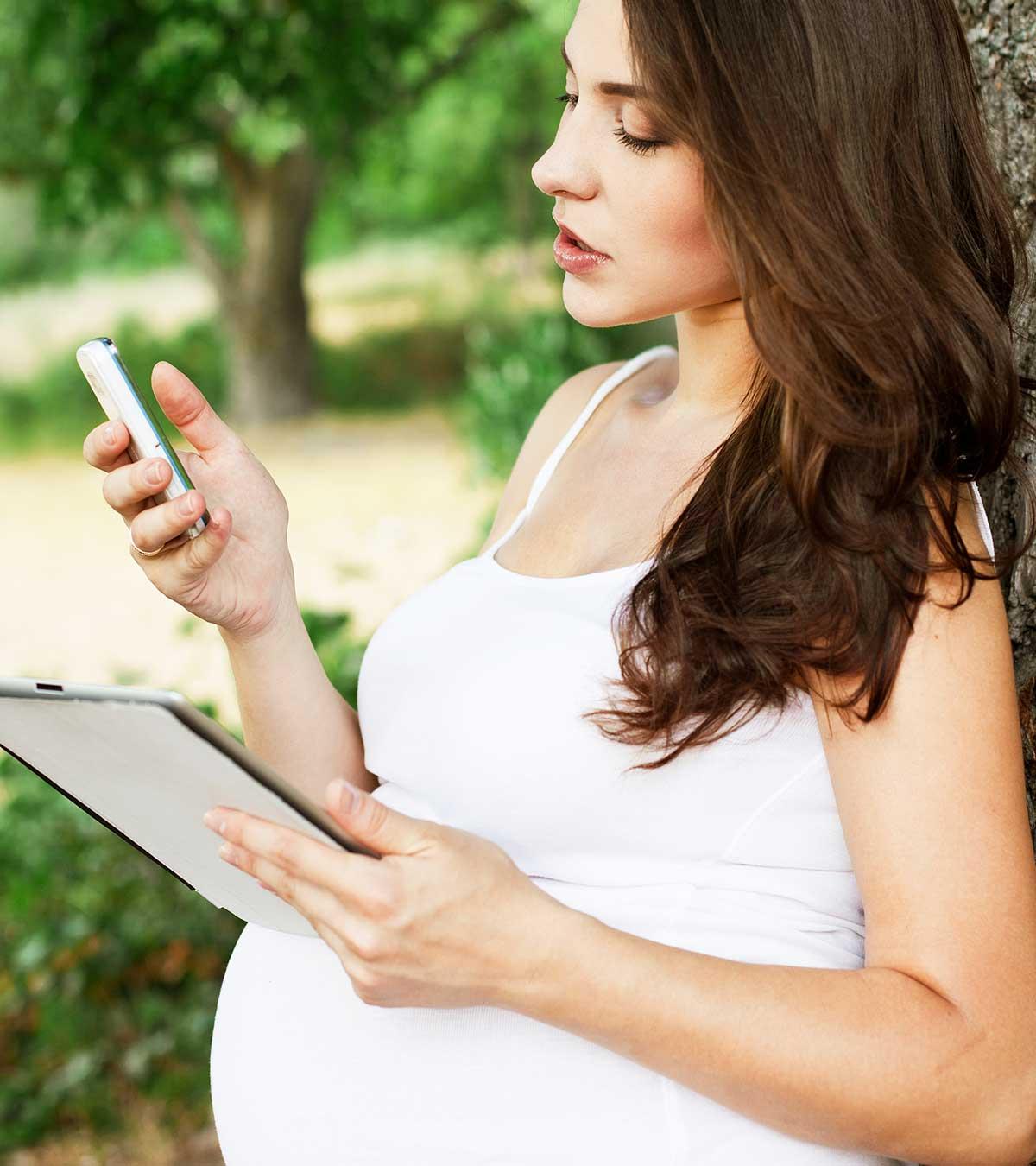 A woman is using mobile while pregnancy
