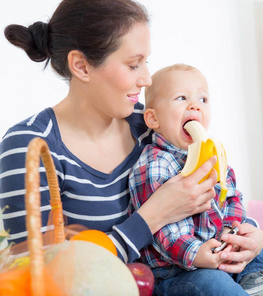 child eating banana