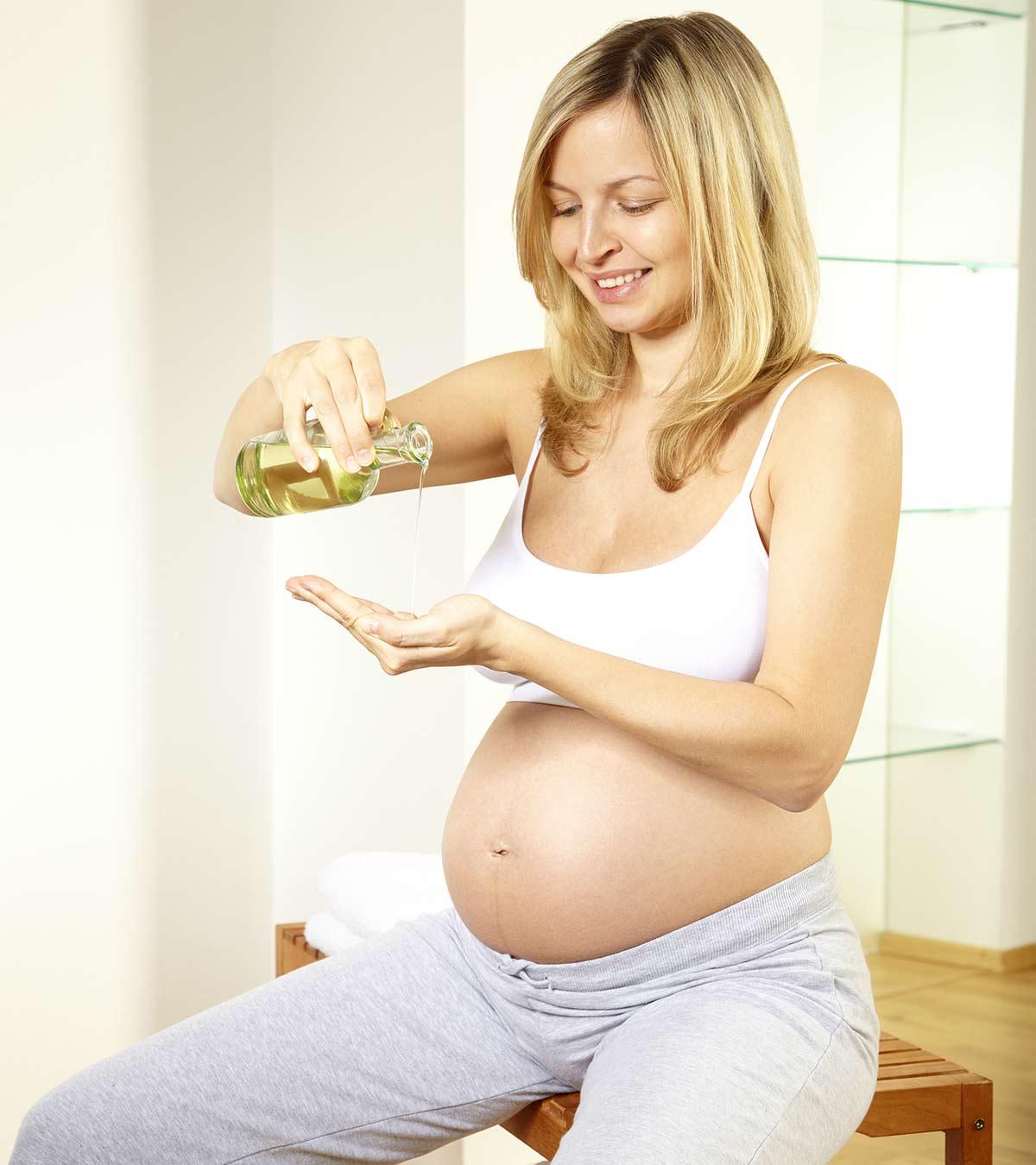 A woman is using almond oil during pregnancy