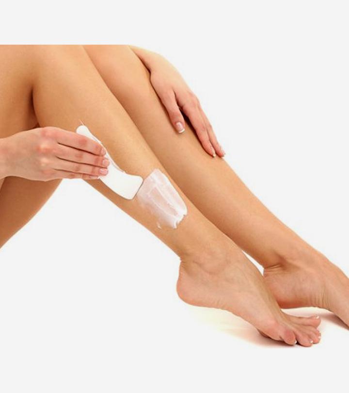 A woman is using depilatory cream for her legs during pregnancy