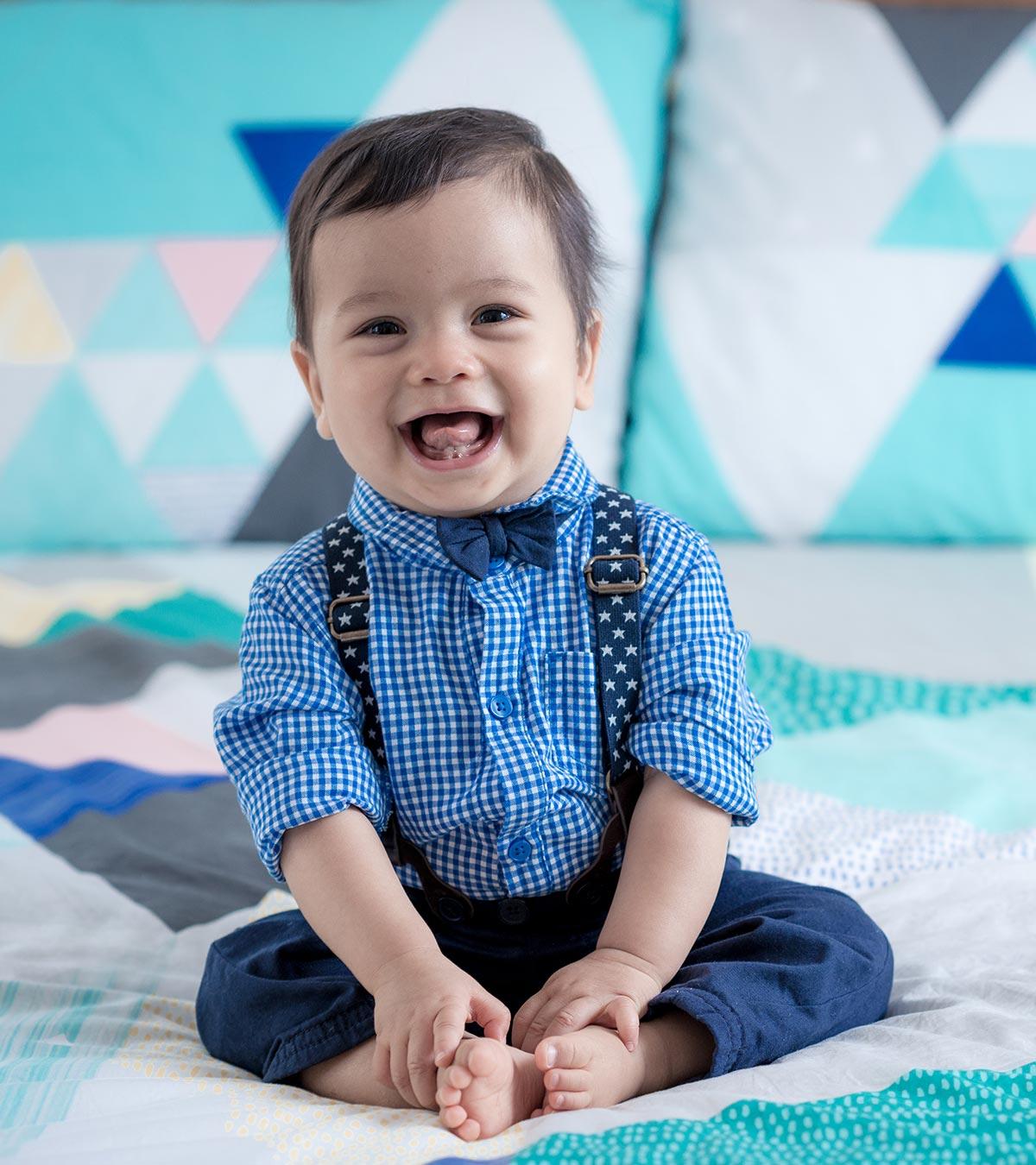 An 11-month-old baby is smiling