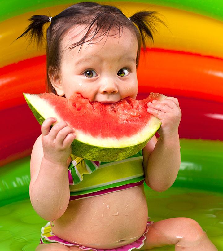 A baby eating watermelon