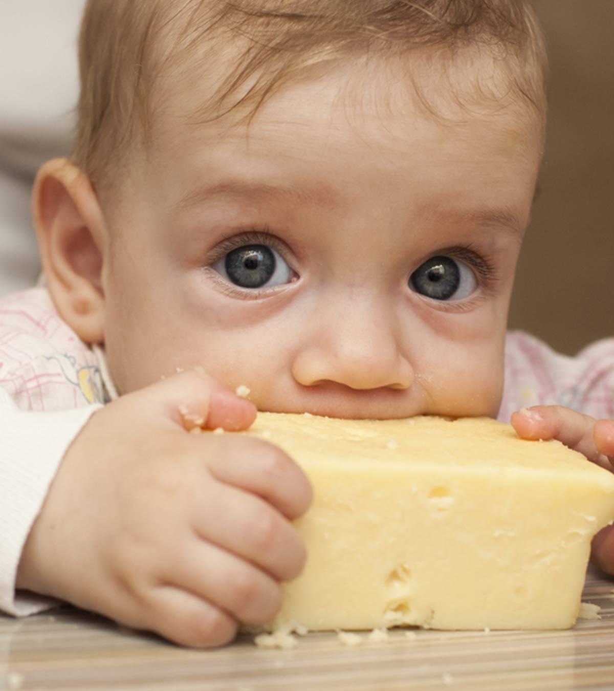 A baby eating cheese