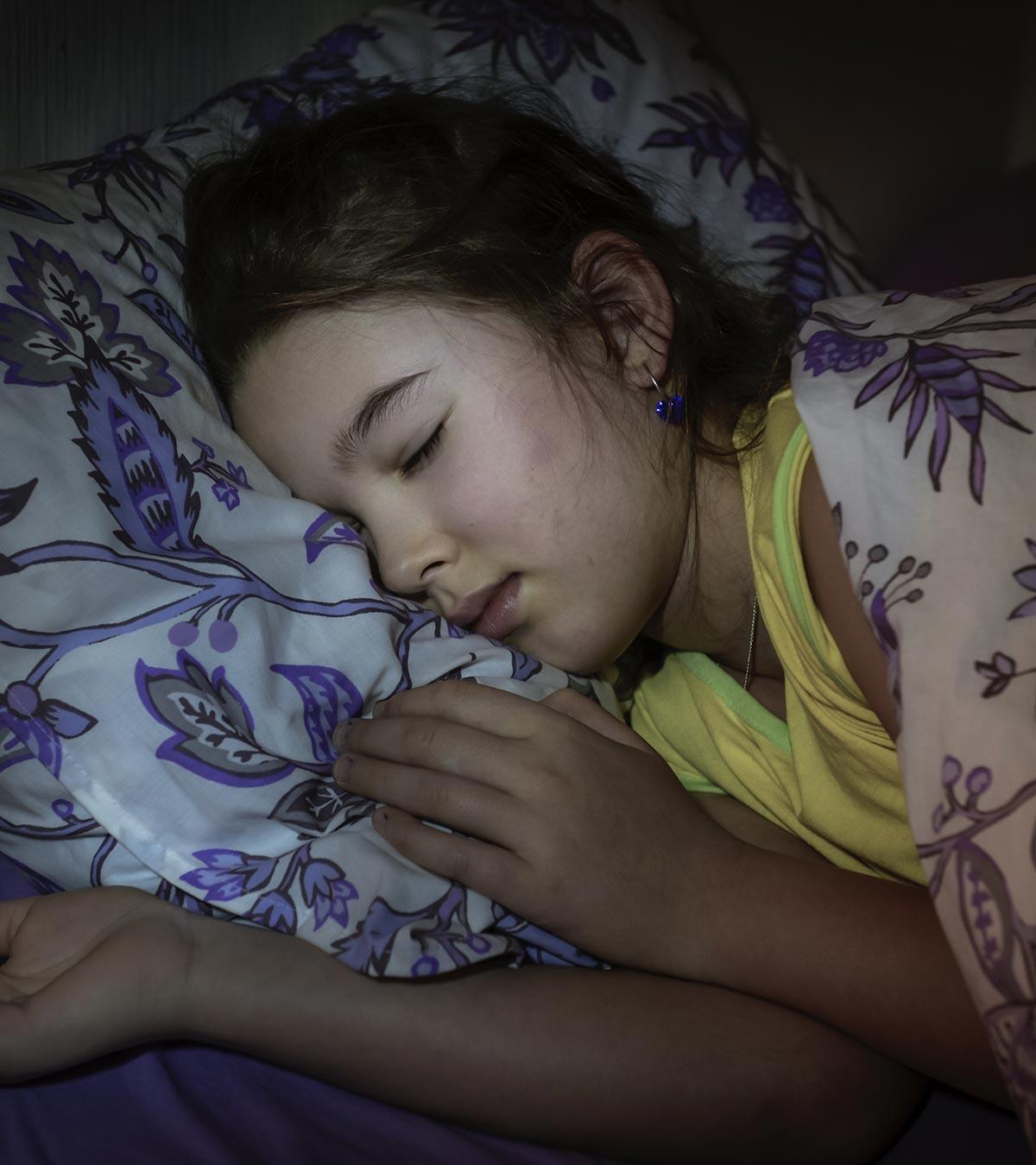 A girl is sleeping in a bad