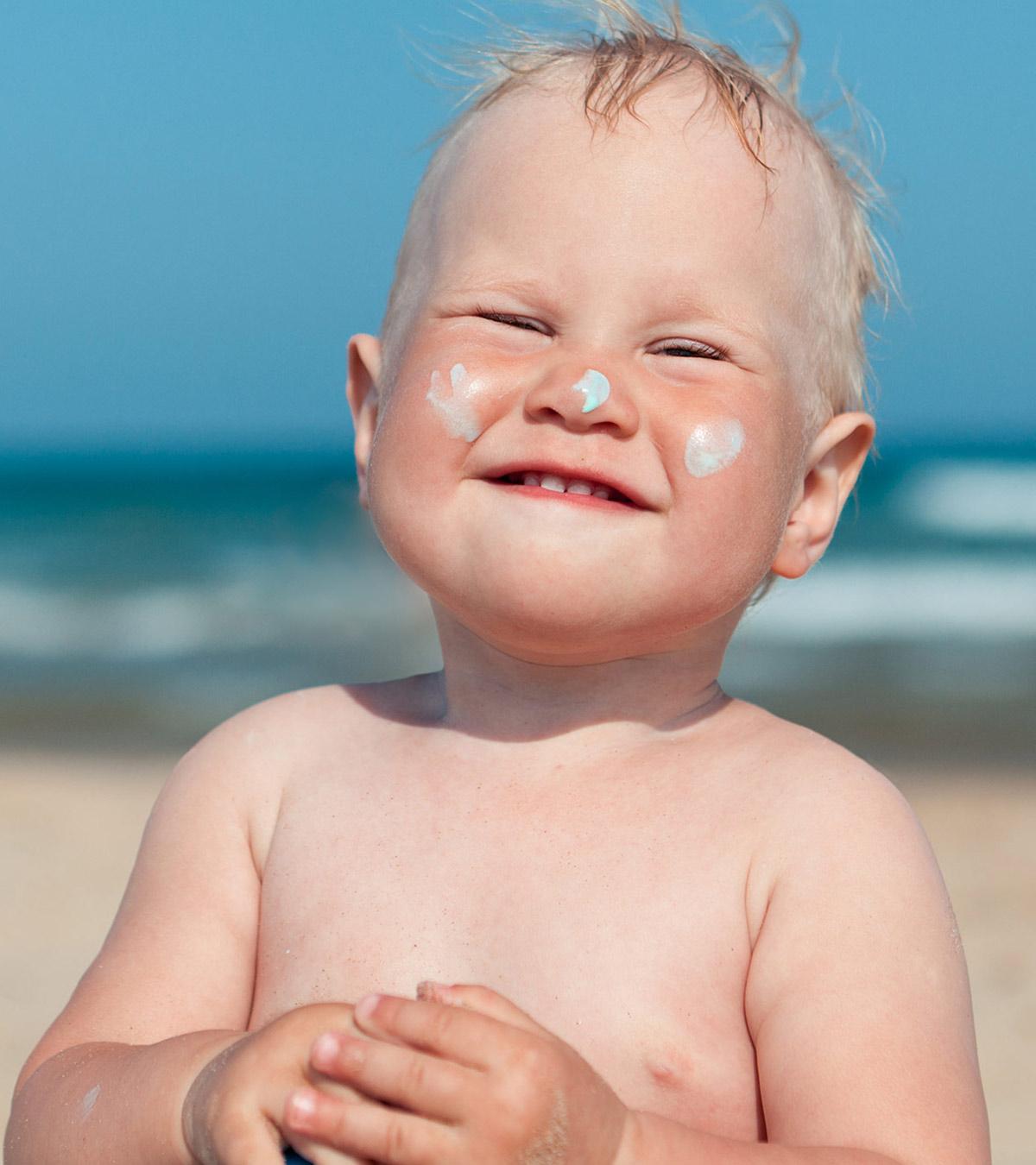 Baby In The Beach With Sunburn