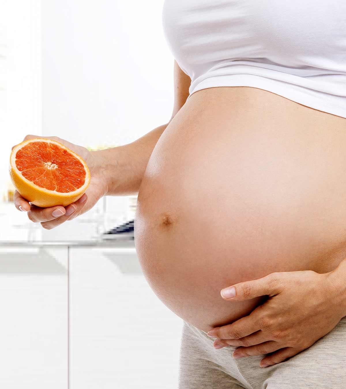 A Pregnant Woman Eating Grapefruit