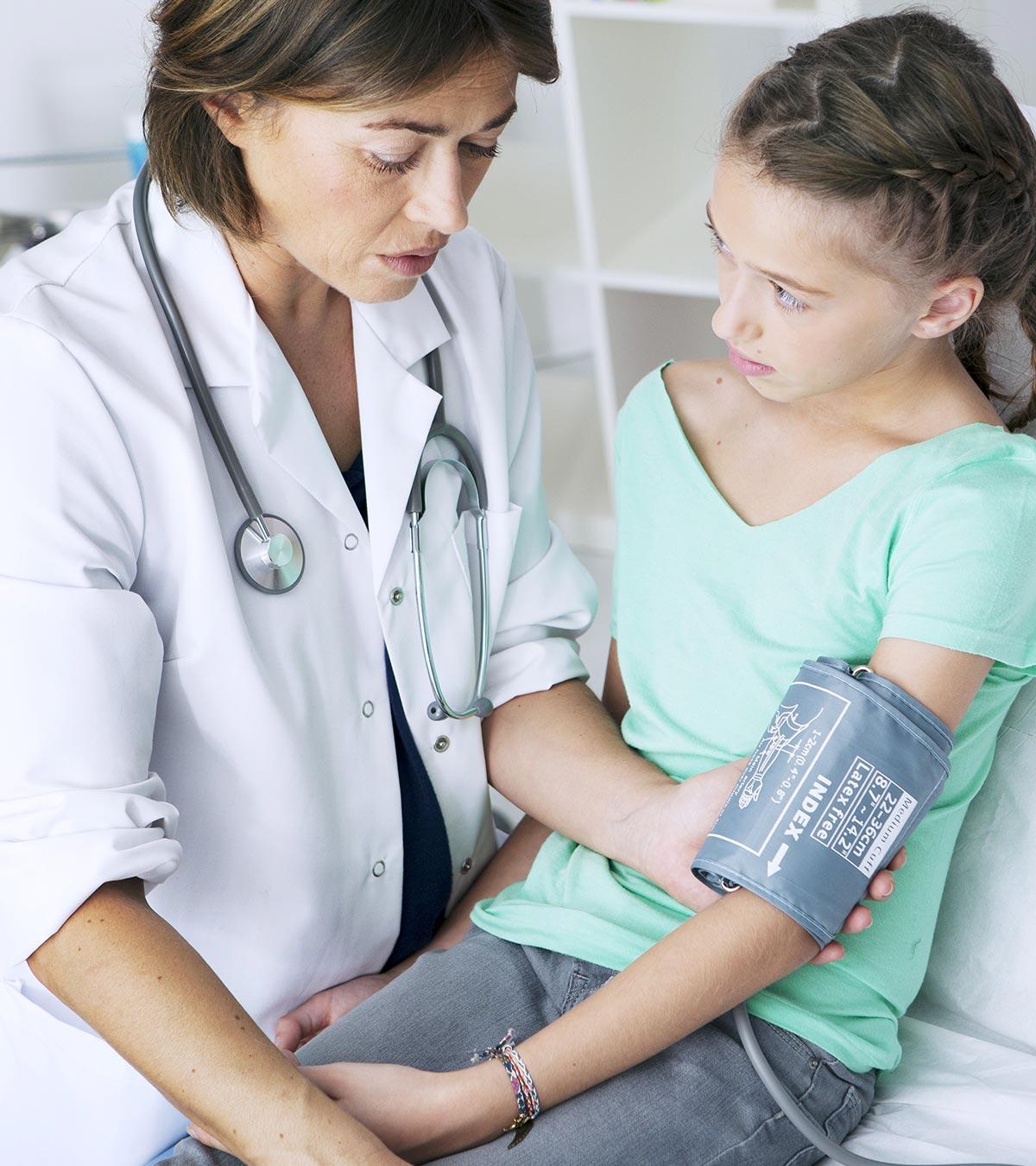 A doctor checking a little girl