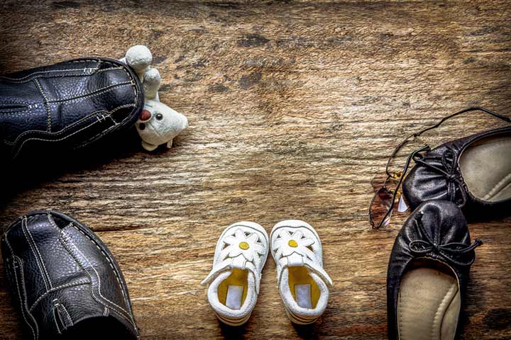 Use a pair of baby shoes to tell your husband you are pregnant