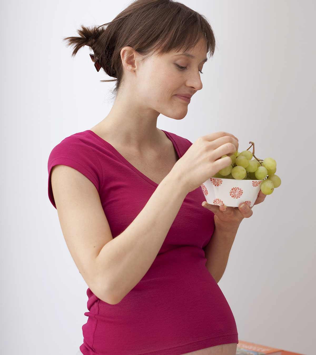 A Pregnant Woman Eating Grapes