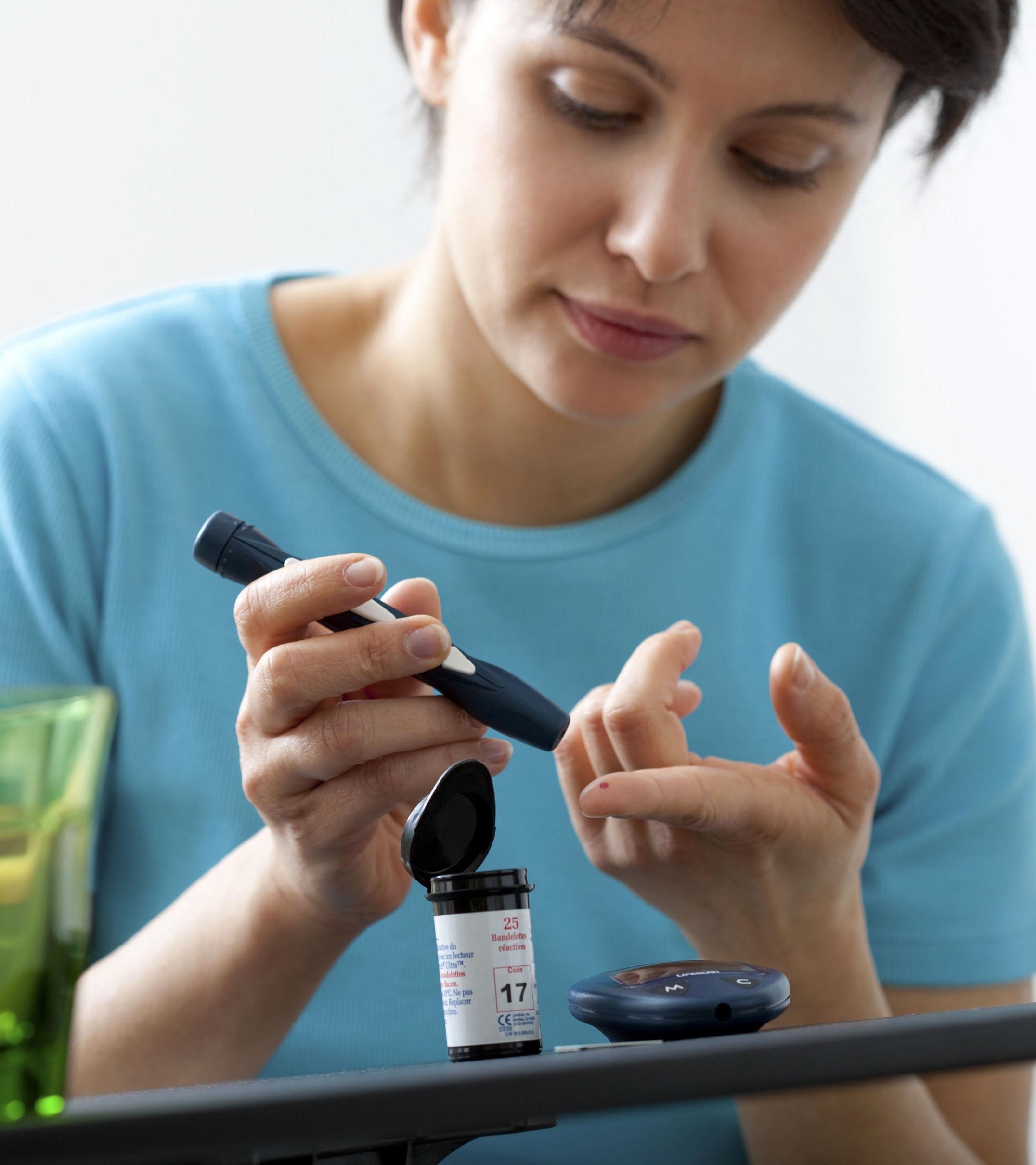 A lady taking her blood sample
