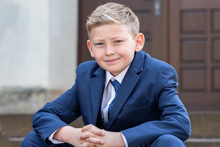 Smiling boy with trendy taper haircut.