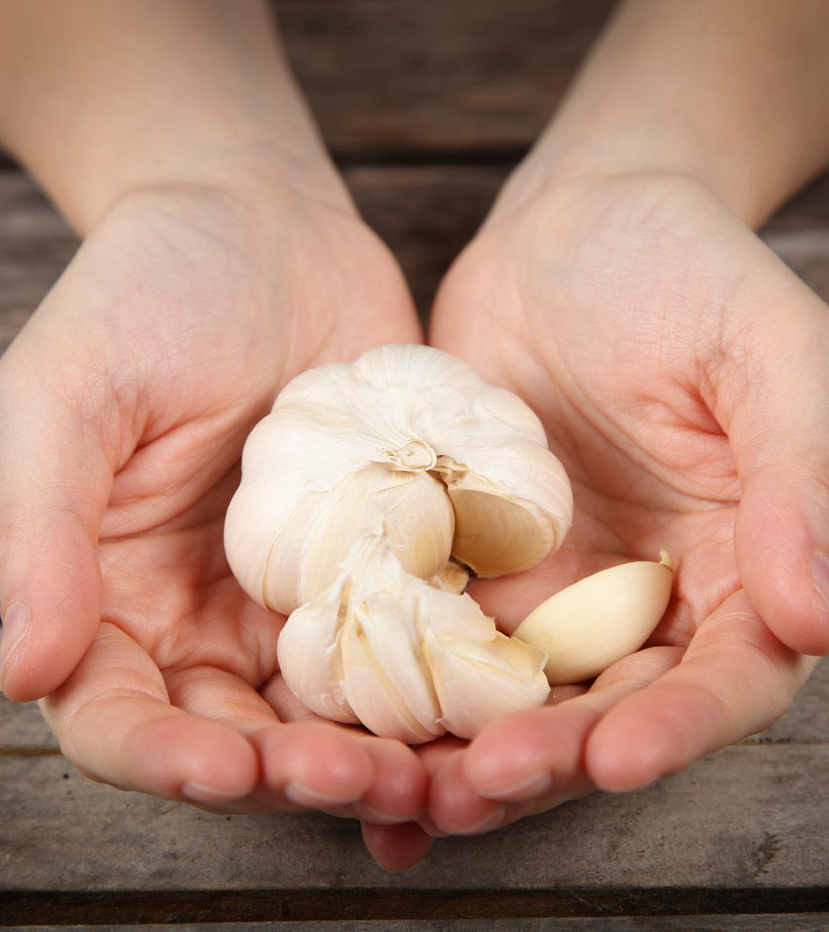 A woman holds some garlic