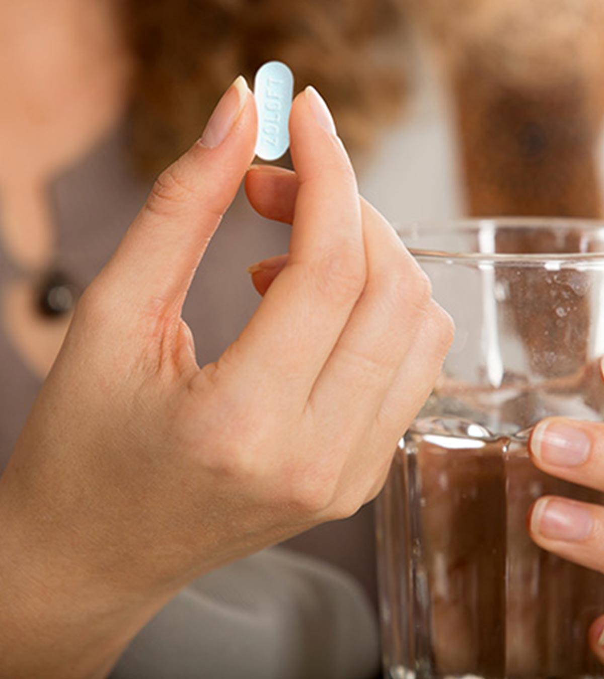 A lady taking Zoloft medicine