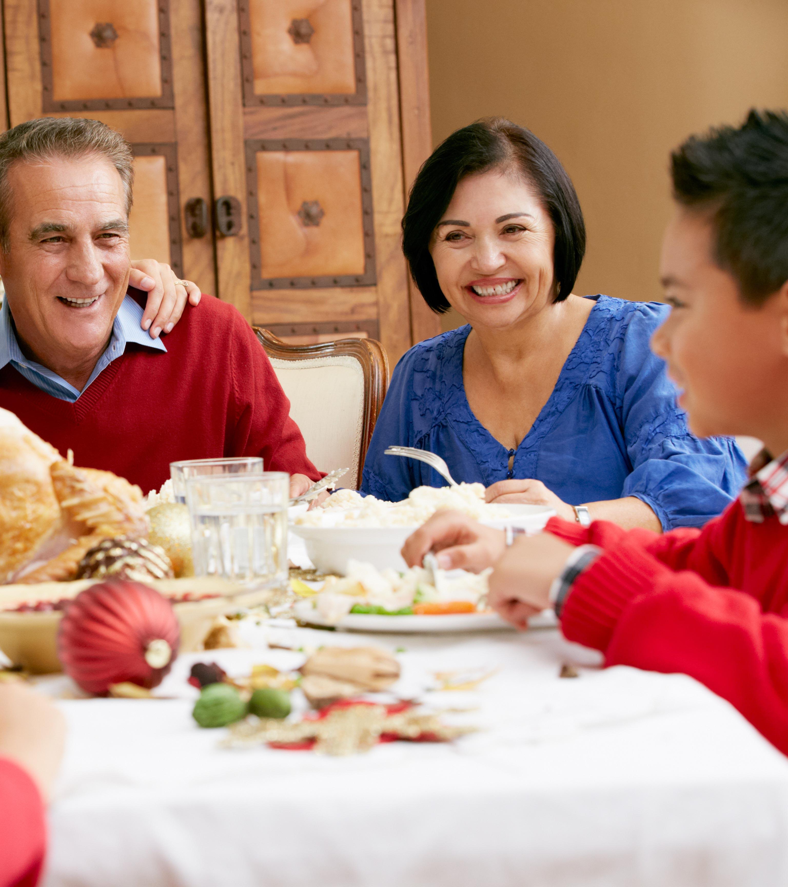 Family members are taking food on the dining table