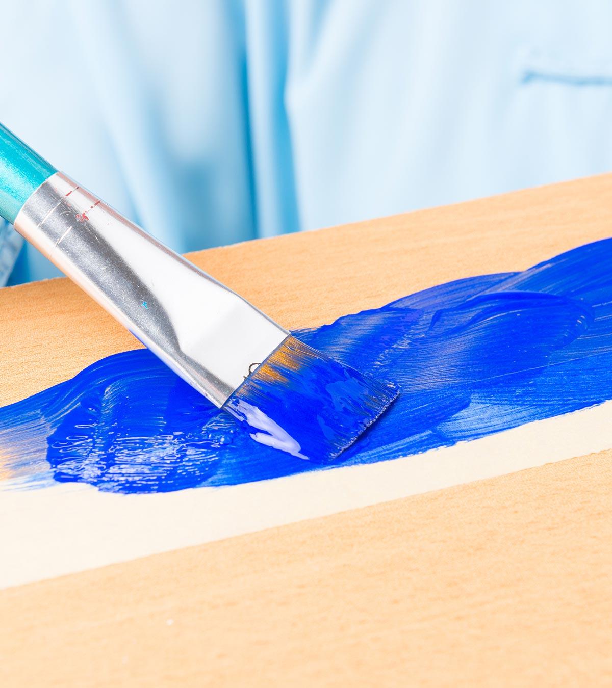Child Painting On A Canvas