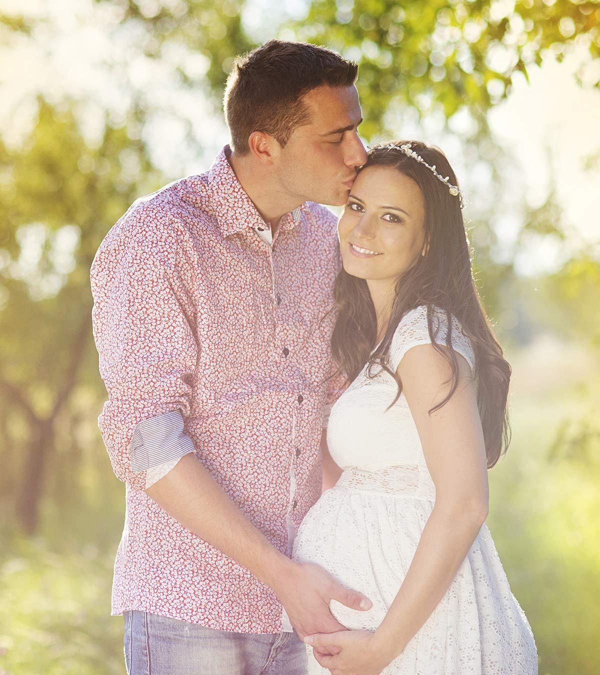 A guy kissing her pregnant wife