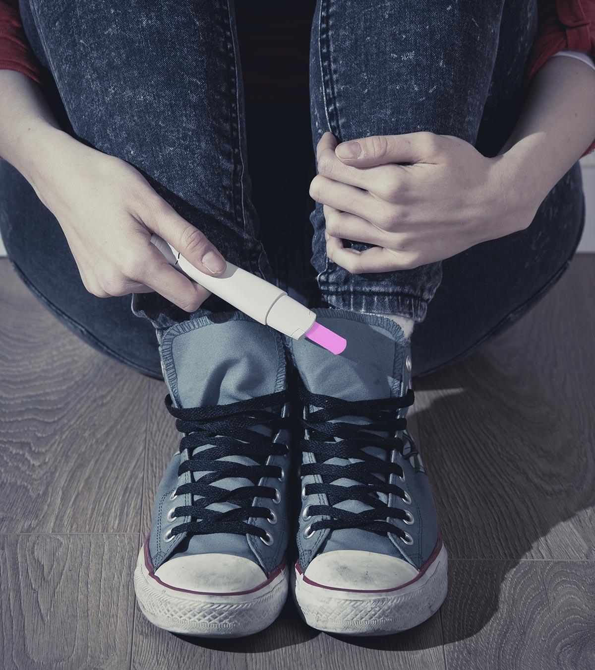 A teenage girl showing her pregnancy result