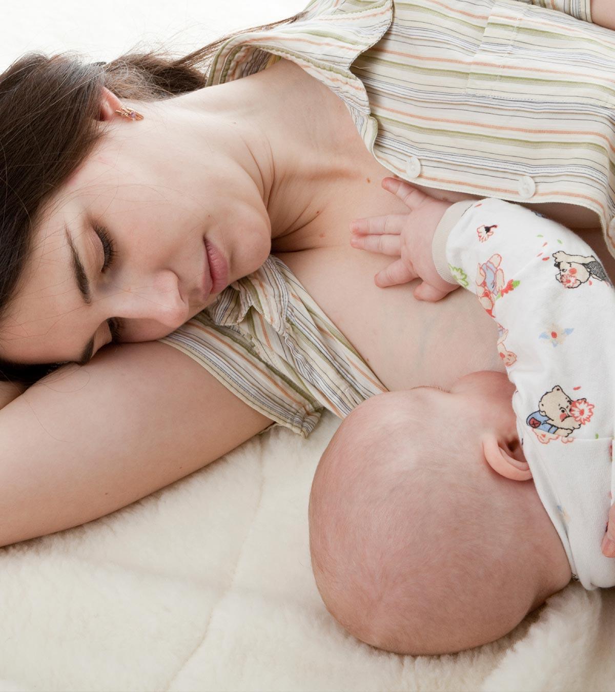 A Mom SLeeping While Breastfeeding Her Baby