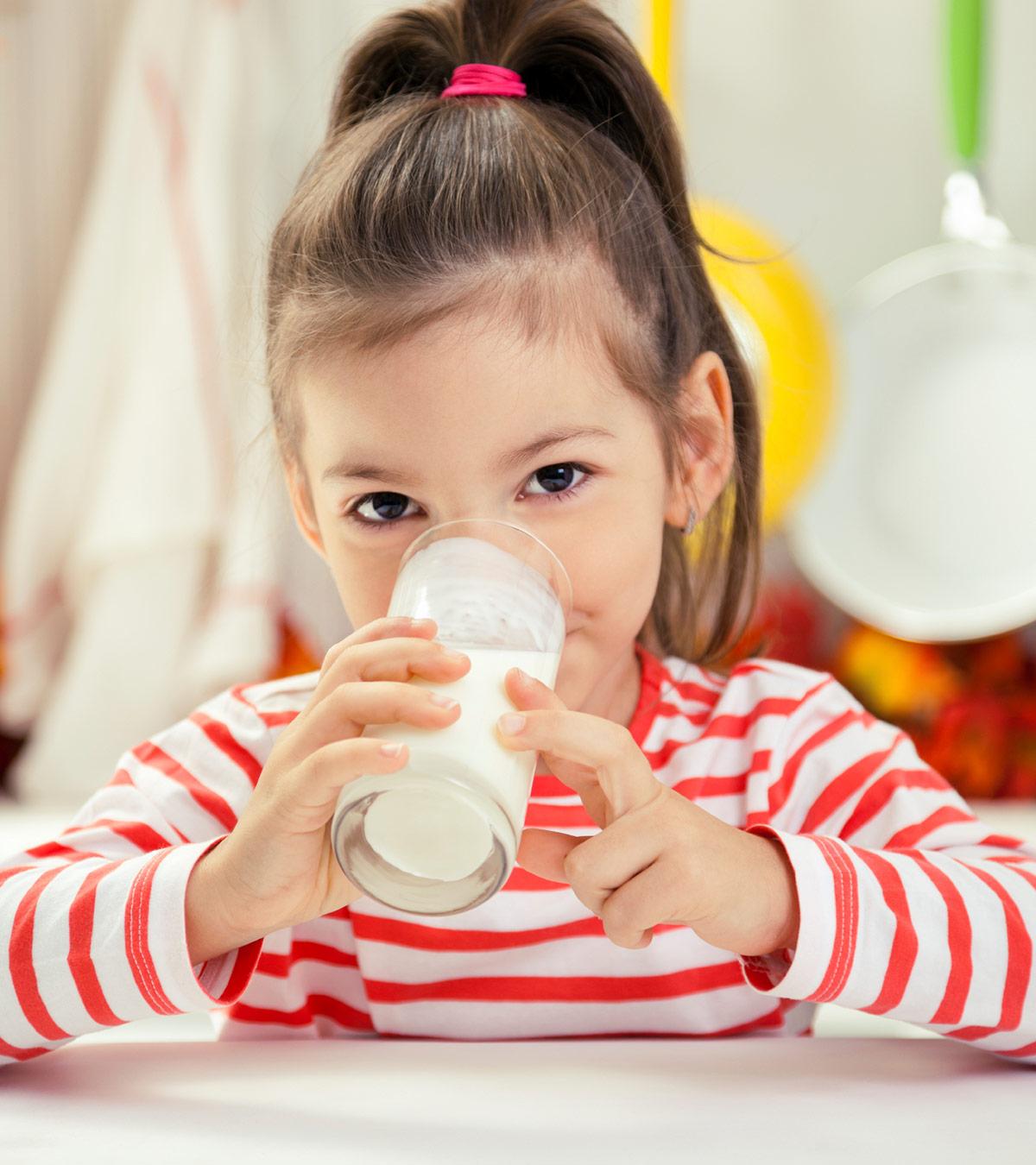 A small girl drinking Pediasure