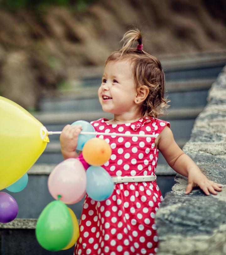Baby Holding Baloons For Second Birthday Party