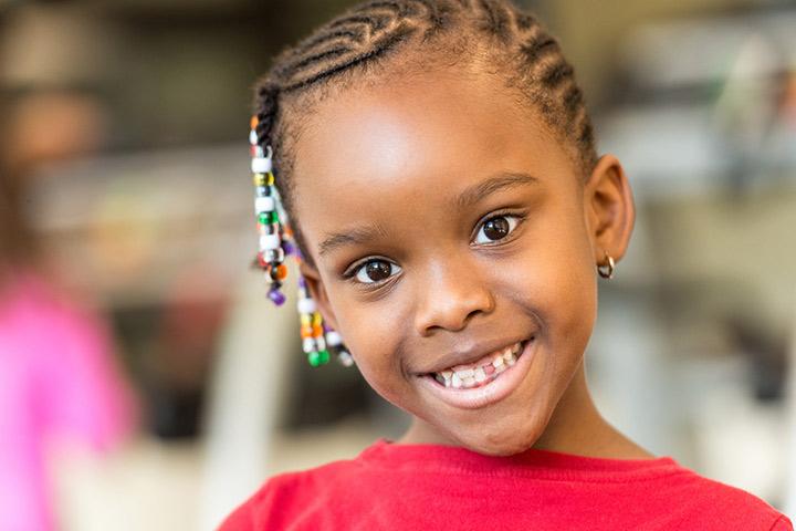 Beaded cornrow curly hairstyle for girls