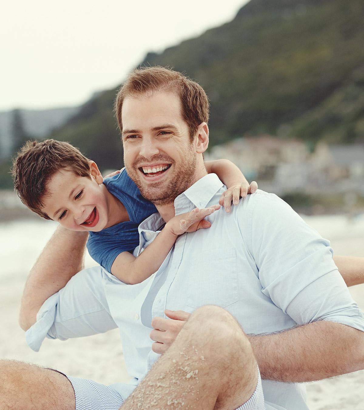 Father And Son Playing At Beach