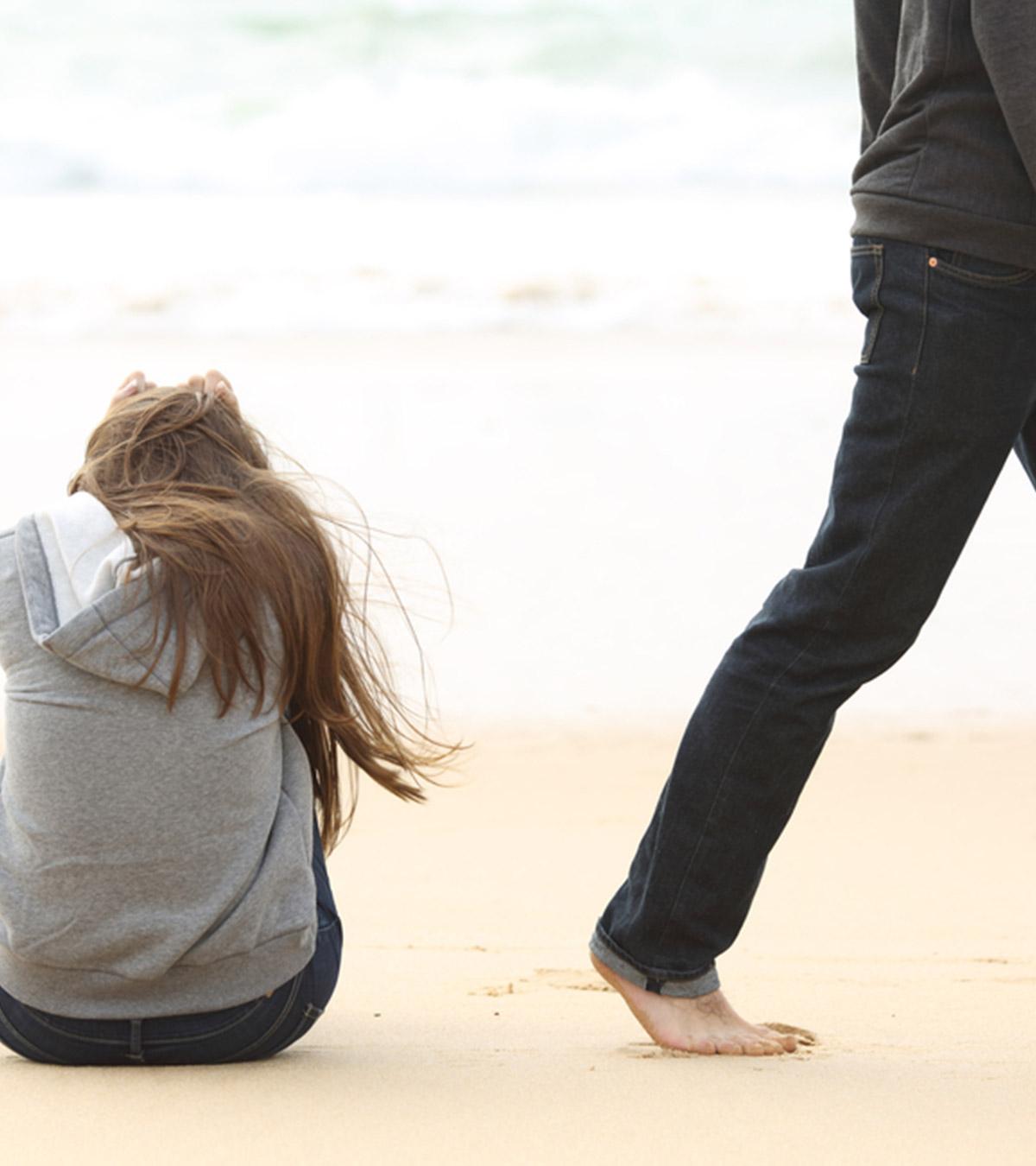 A guy goes away from the girl after a breakup