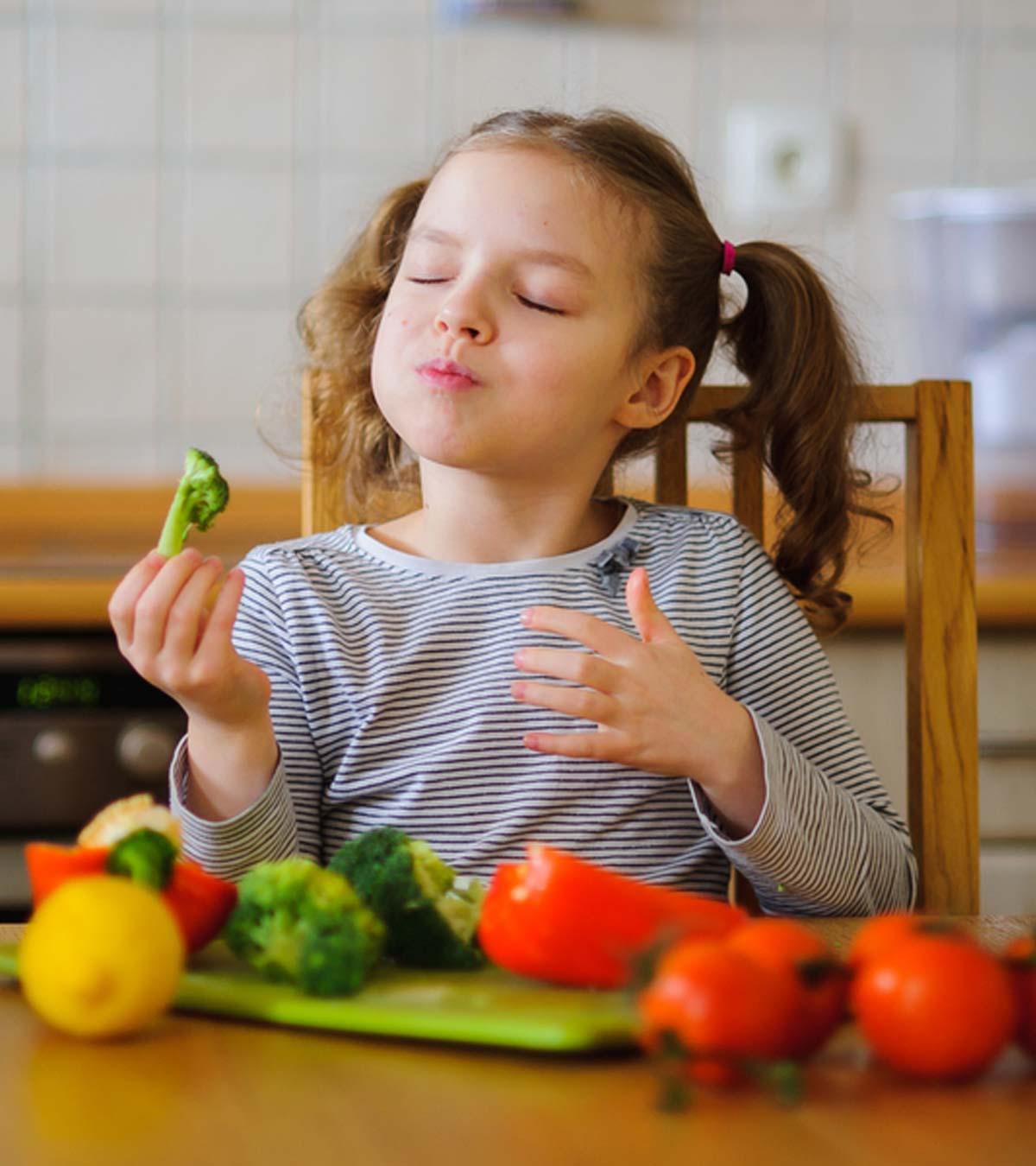 A kid eating broccoli