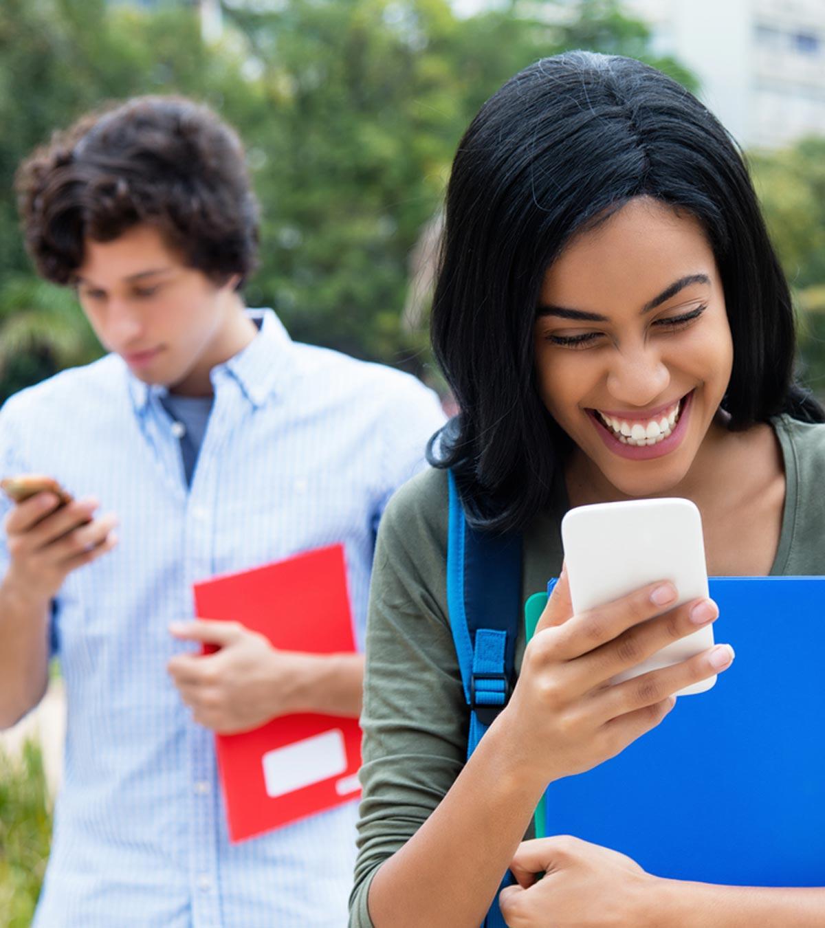 A woman is laughing after sending an intimate question over a text