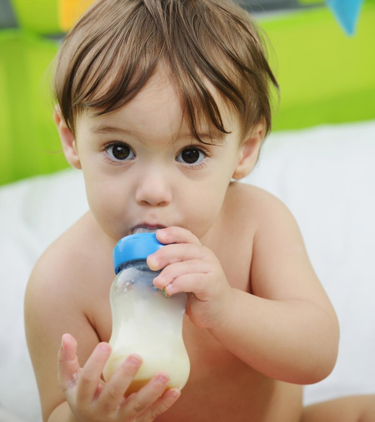 Baby Drinking From A Bottle Of Formula Milk