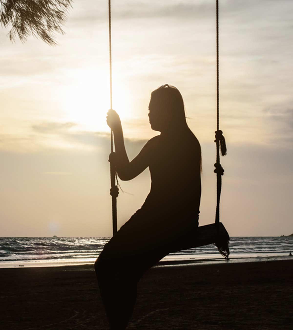 A girl sitting alone on a beach