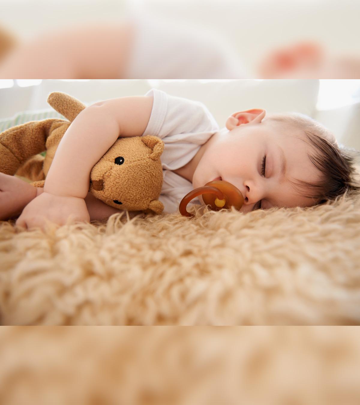 A Baby Sleeping On The Floor