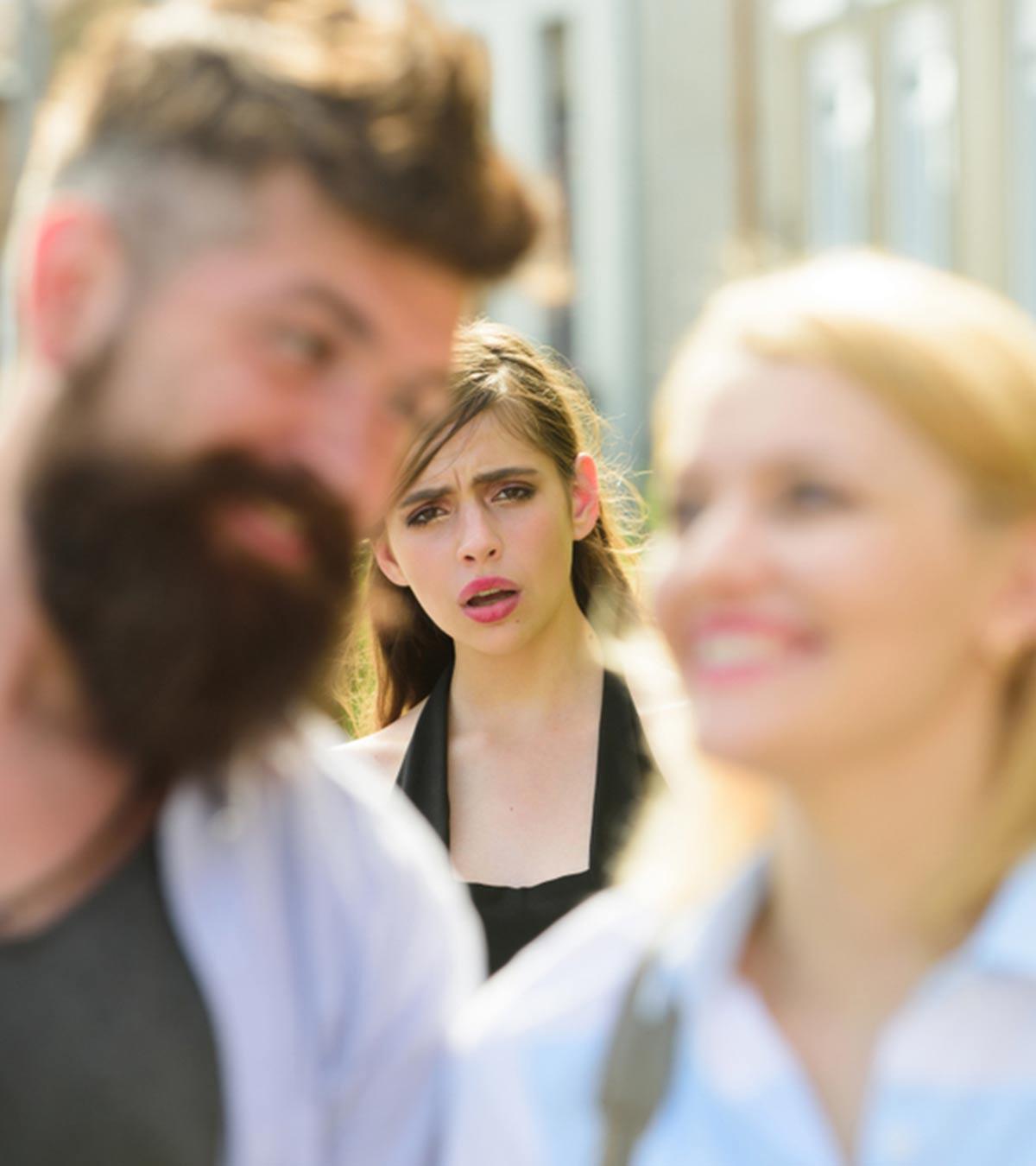 Man Playfully Interacting With Another Girl Making His Girlfriend Feel Jealous
