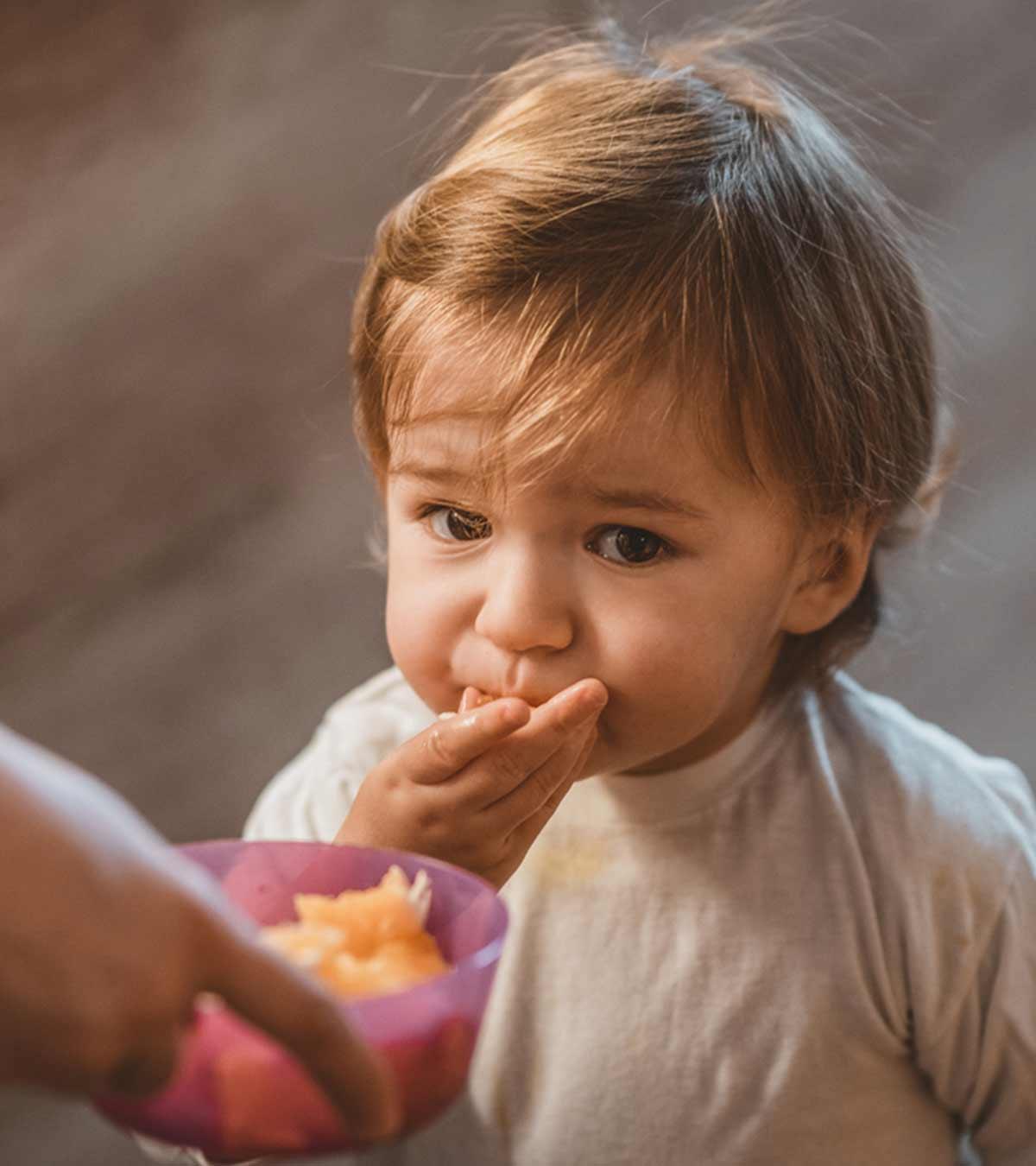 Parent helping their baby learn to chew and swallow