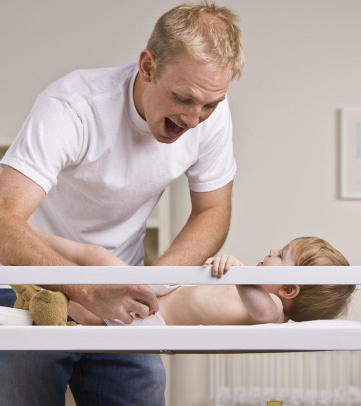 A father changing the diaper of his baby