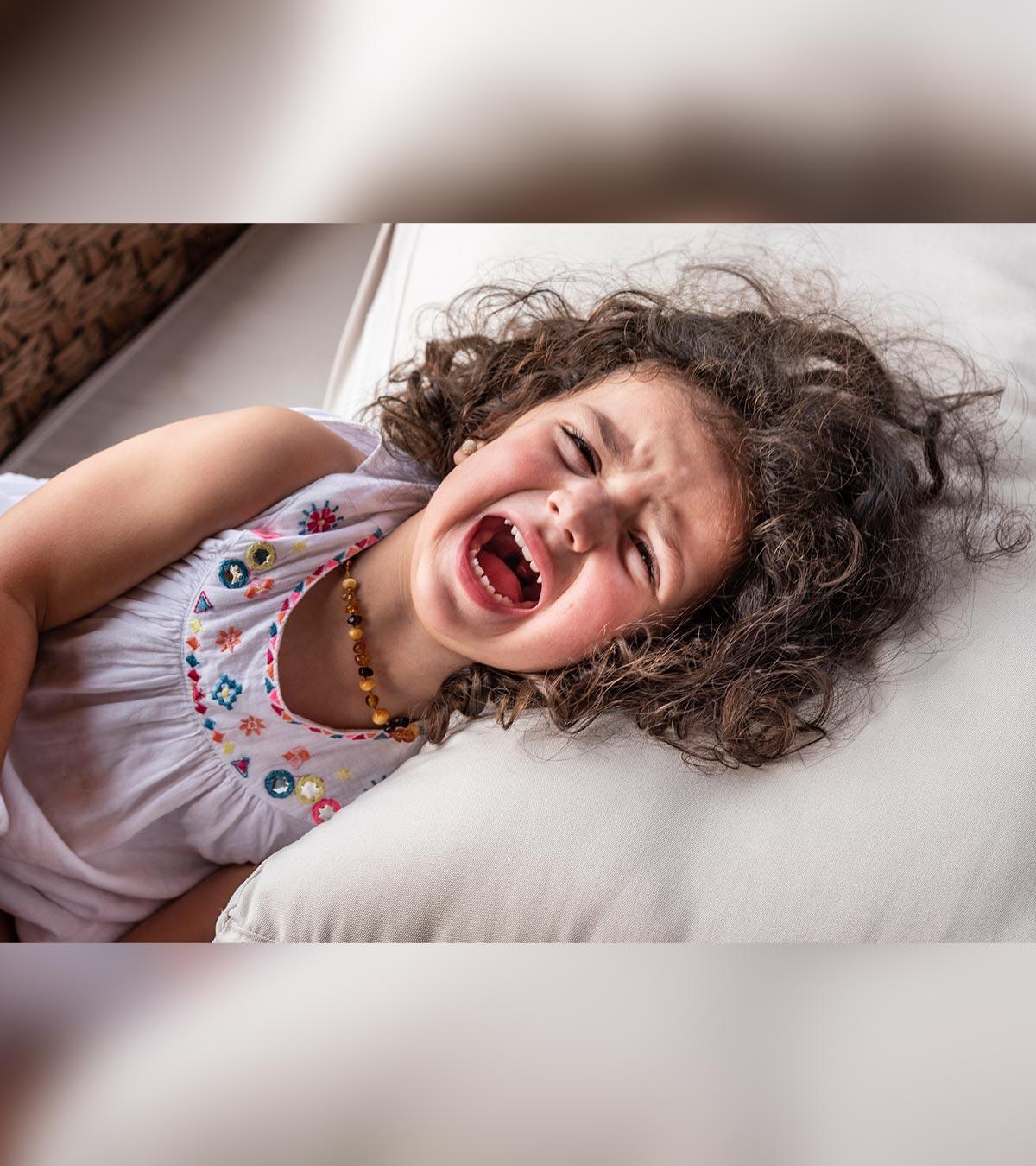 A small baby crying in bed