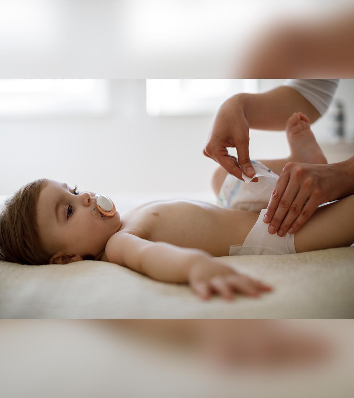 A person changing the diaper of a baby