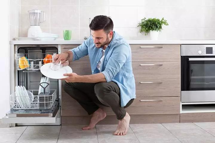 handsome-man-unloading-dishwasher