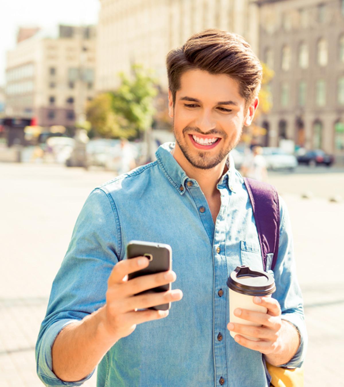 Guy Smiling While Receiving Texts