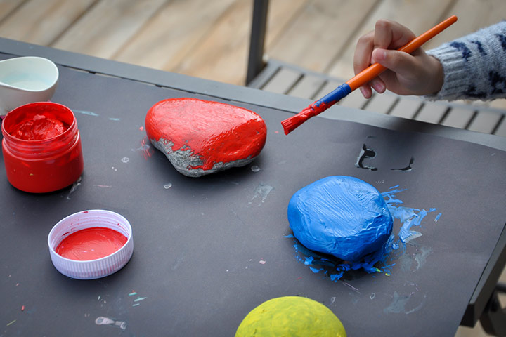 Rock hunting and painting camping activity for toddler