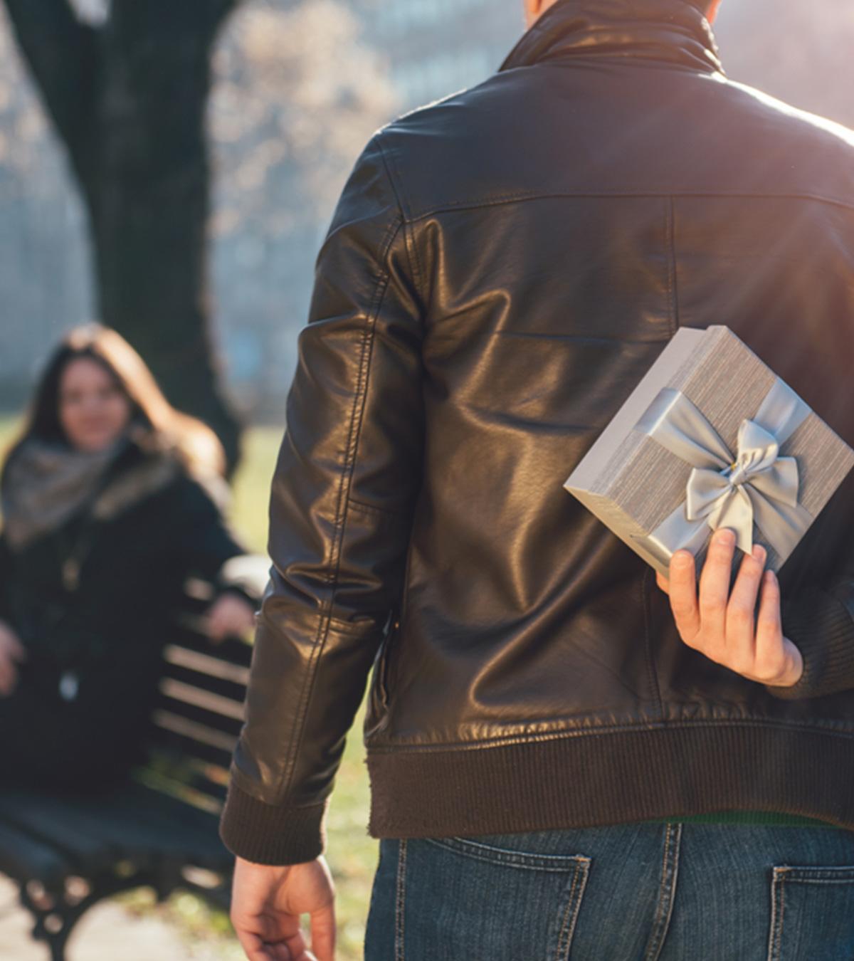 Guy Holding A Gift To Surprise His Girlfriend