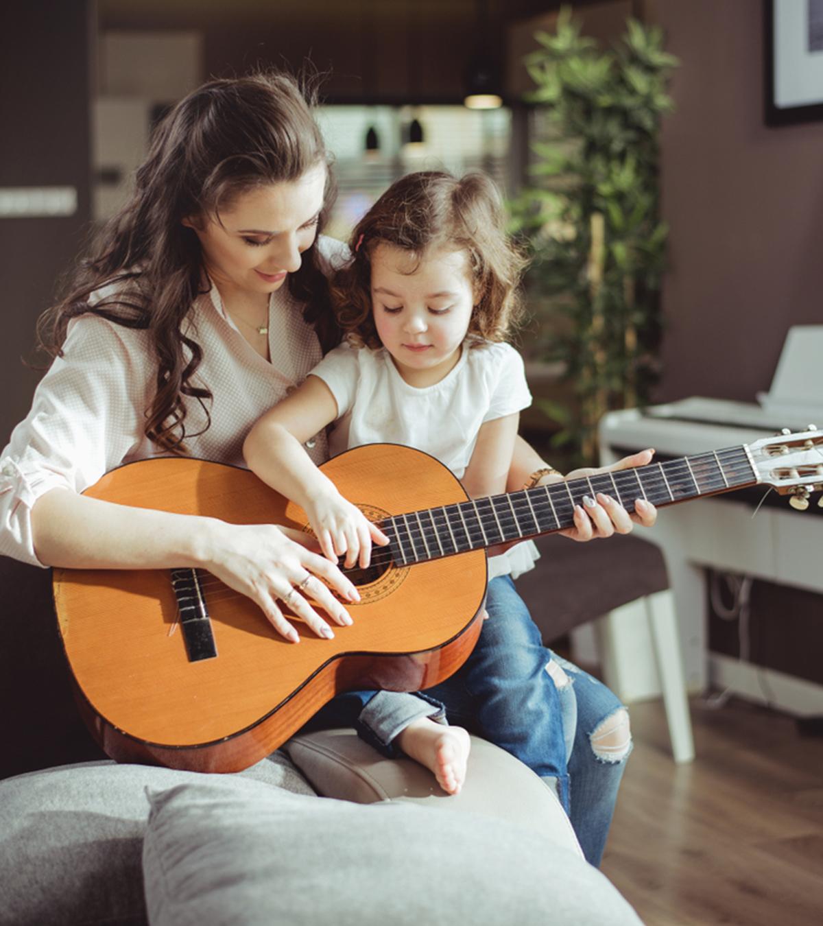 Mother-Daughter Singing Songs And Playing Guitar