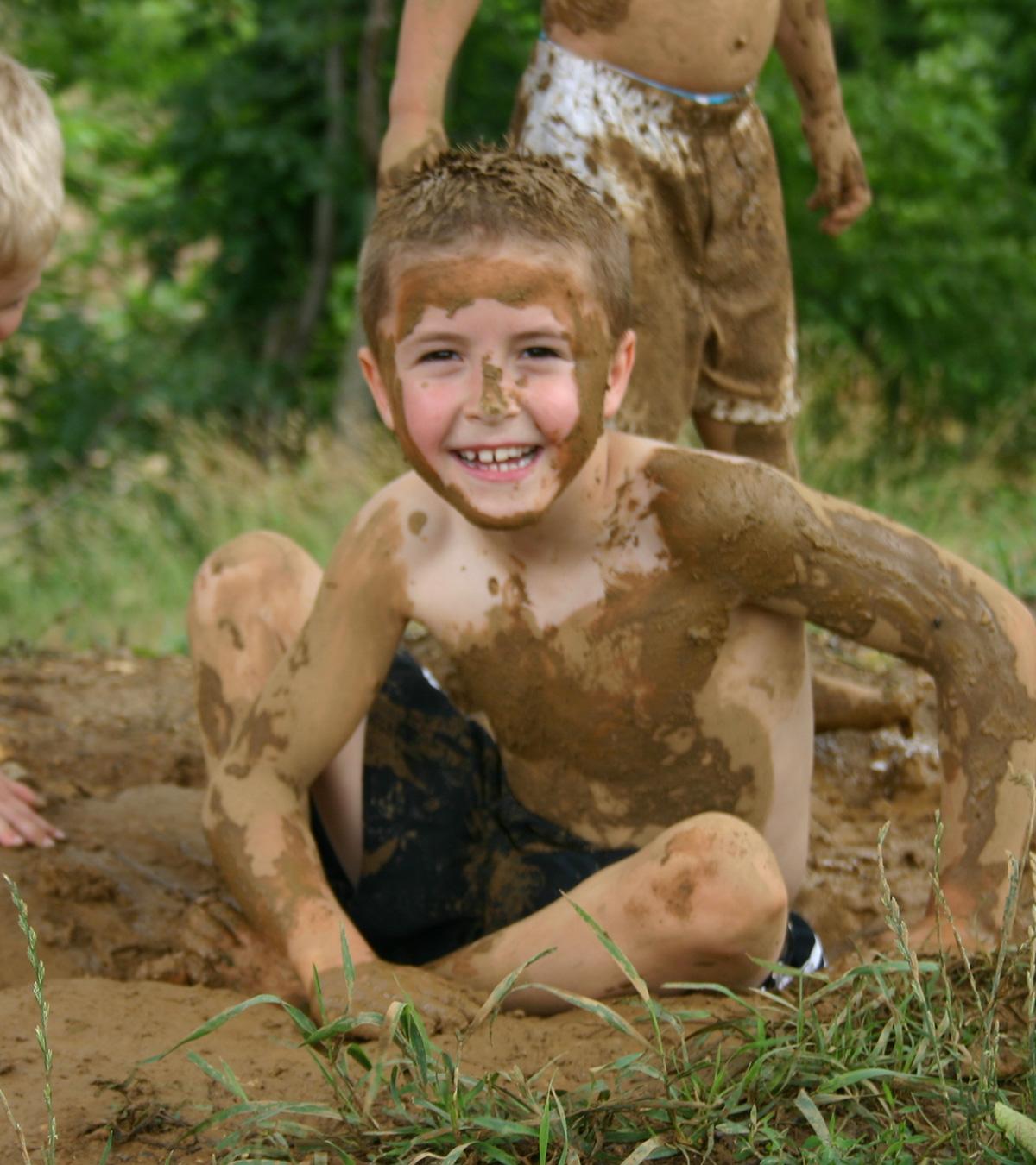 Children Playing In Mud, Indicating Benefits Of Outdoor Play