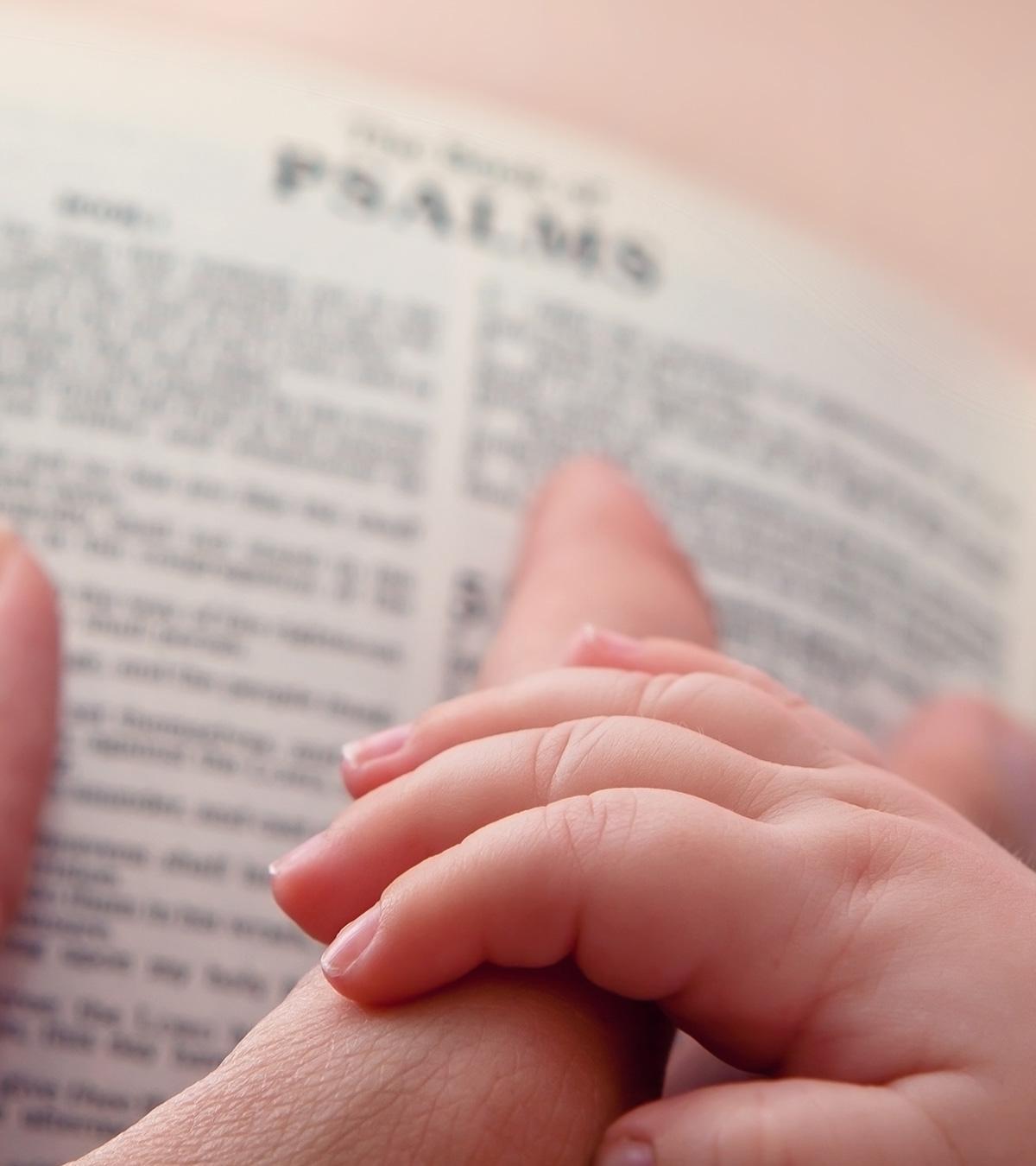 A mother with her baby reading bible verses