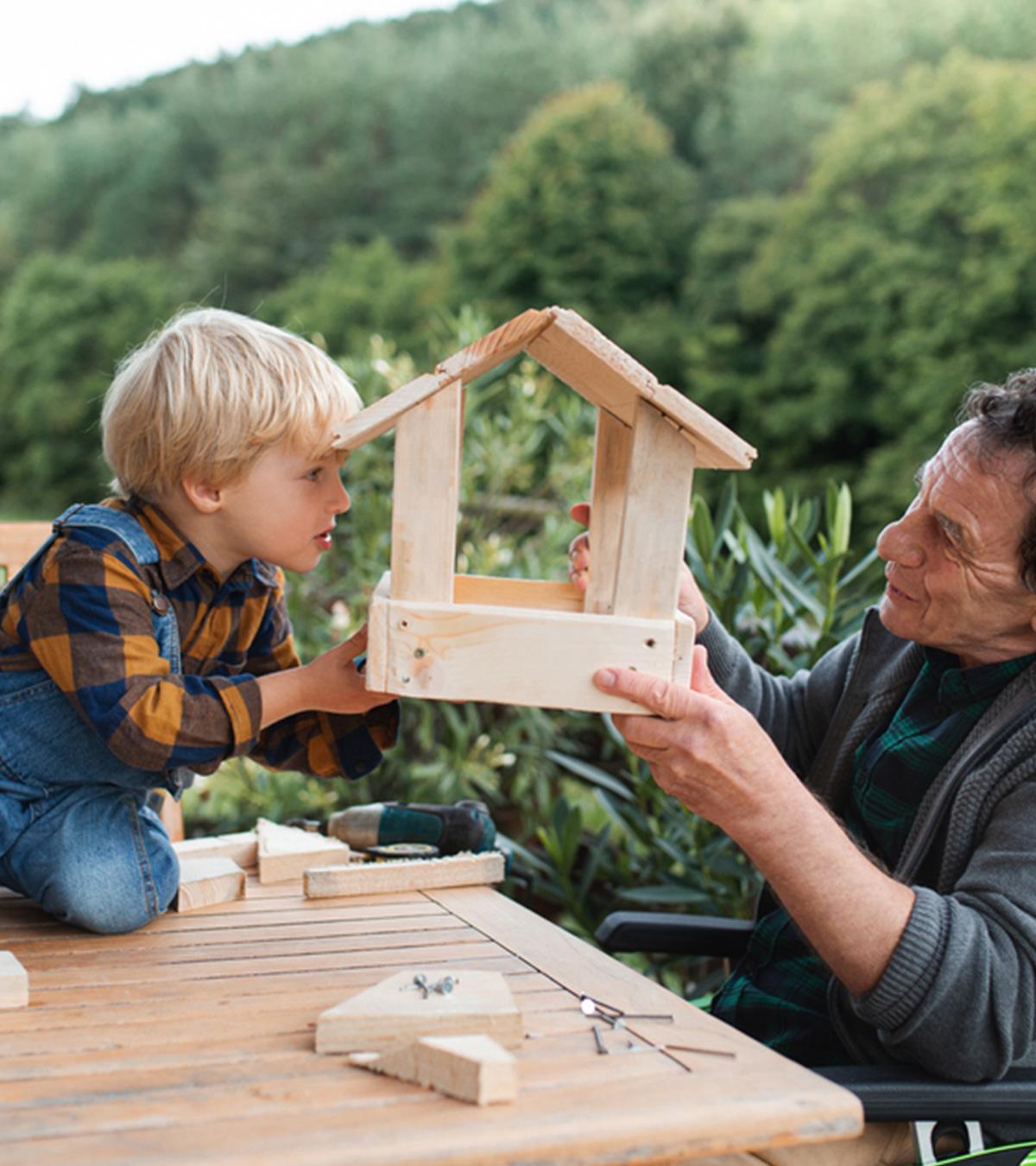 A kid preparing homemade bird feeders with his grandfather