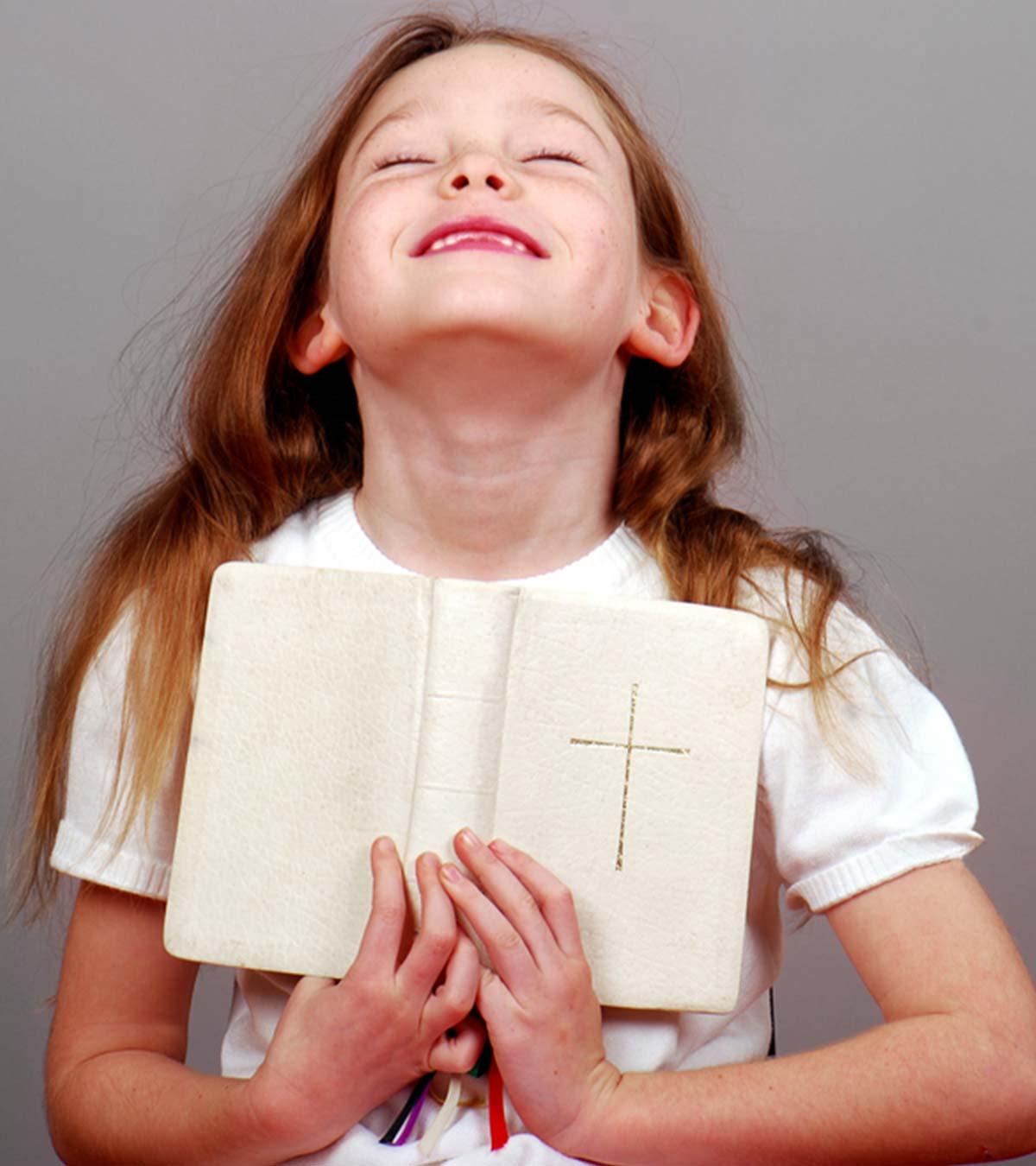 A small girl reading the bible