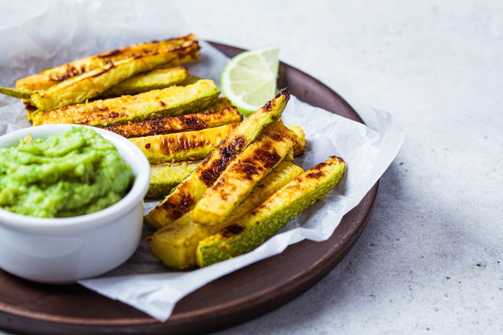 Baked zucchini sticks with guacamole, vegetable snacks for kids