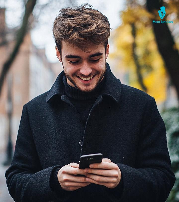 Man Looking At Phone And Smiling
